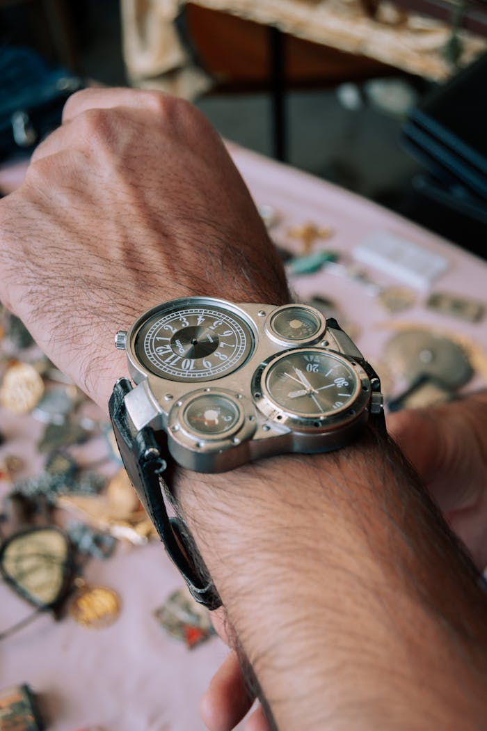 Close-up of a unique steampunk style wristwatch on a man's wrist, emphasizing detail and design.